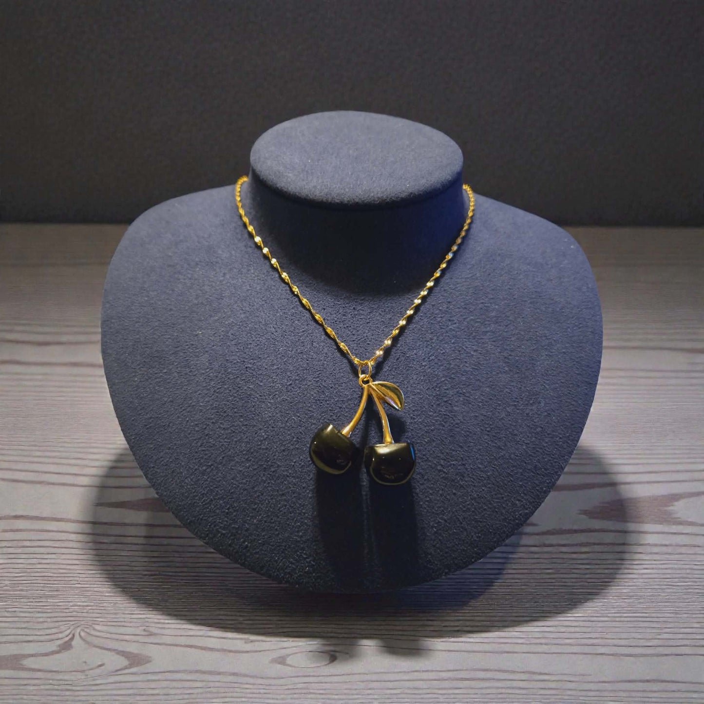 Zinc Based Alloy Gold Plated Black Cherry Charm on a 18K Gold PVD Stainless Steel Singapore Chain Necklace