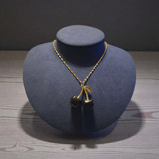 Zinc Based Alloy Gold Plated Black Cherry Charm on a 18K Gold PVD Stainless Steel Singapore Chain Necklace